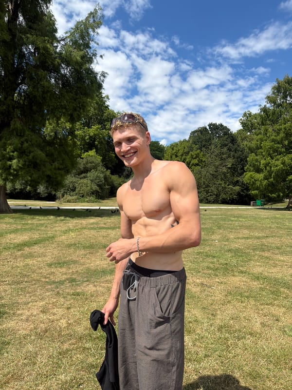 Shirtless and relaxed in a London park on a sunny afternoon