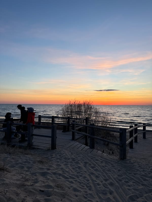 Evening crowd gathers on Riga boardwalk for sunset viewing