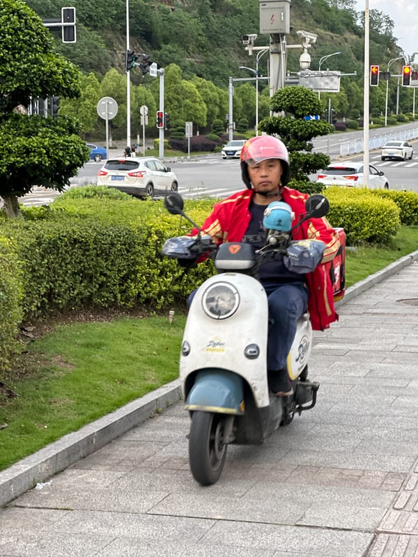 Delivery driver, pedestrians observed on Jiangjin street during morning