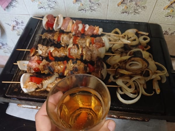 Family barbecue gathering with grilled skewers in Obrochishte, Bulgaria