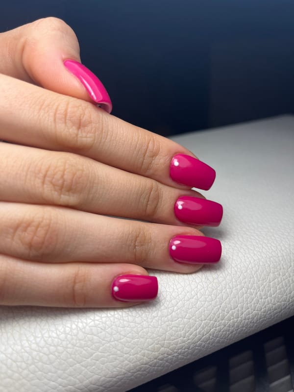 Magenta manicure with white dots photographed in Pernik