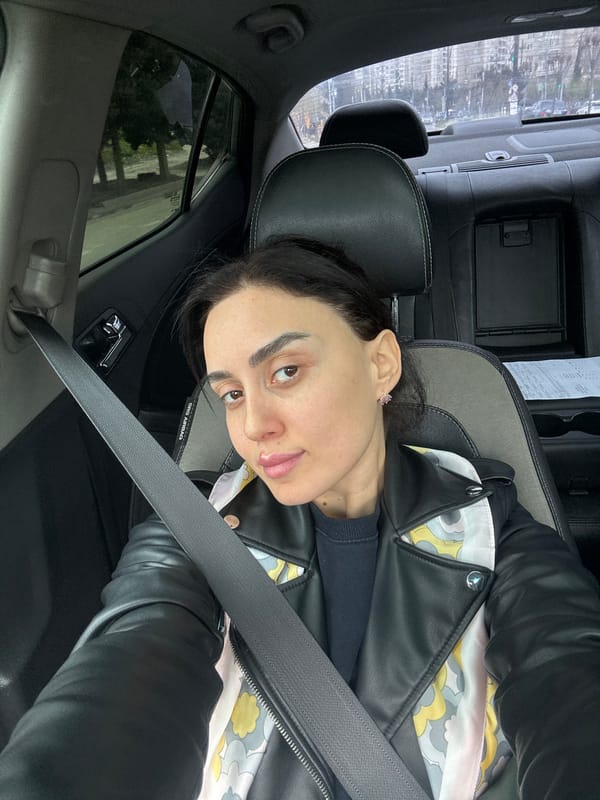 Woman takes selfie in car in urban Tbilisi