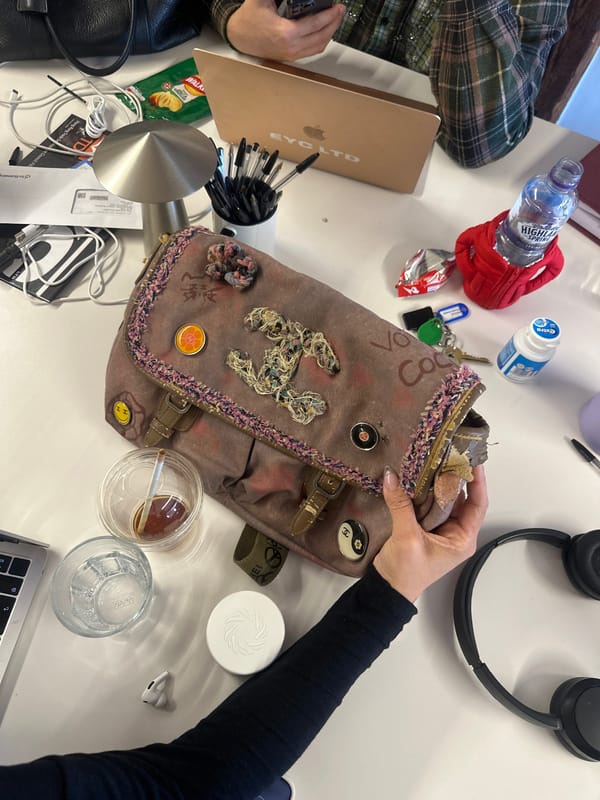 Two people work at cluttered desk in London office