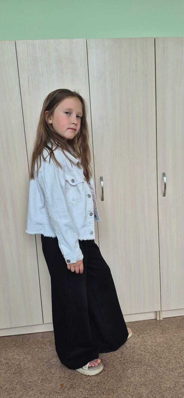Girl in white jacket captured in indoor poses
