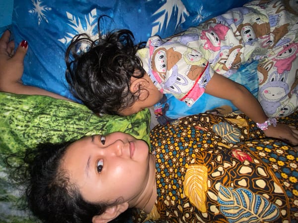 Mother and child share quiet moment together on bed