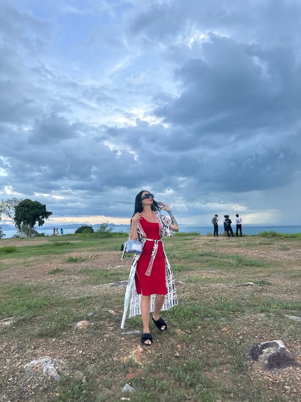 Tourists gather at Thai coastal viewpoint under dramatic skies