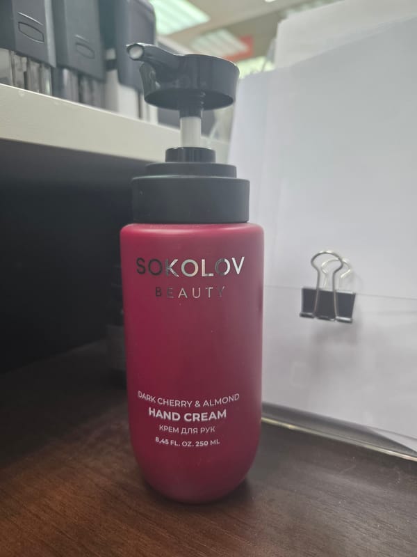Hand cream bottle observed on wooden surface with product residue