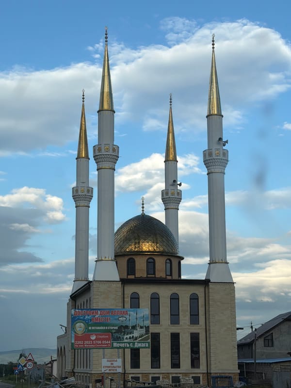 Golden-domed mosque with four minarets in Джага, Russia