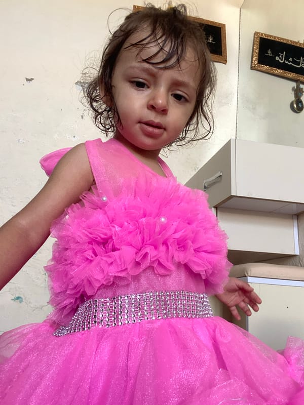 Toddler in pink dress photographed in Kandahar