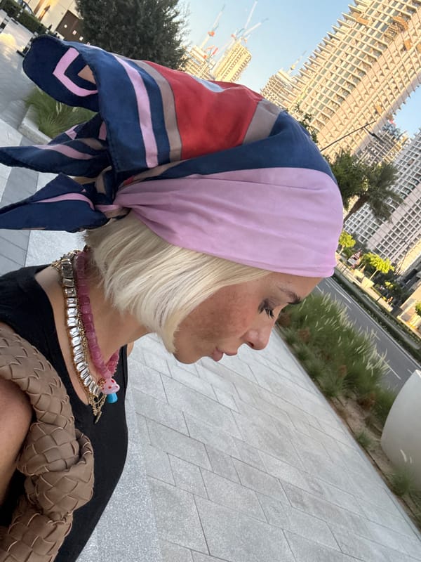 Woman in colorful headscarf photographed around Dubai