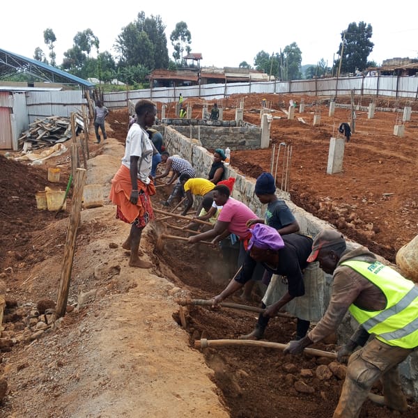 Construction workers dig trenches at Kenya building site
