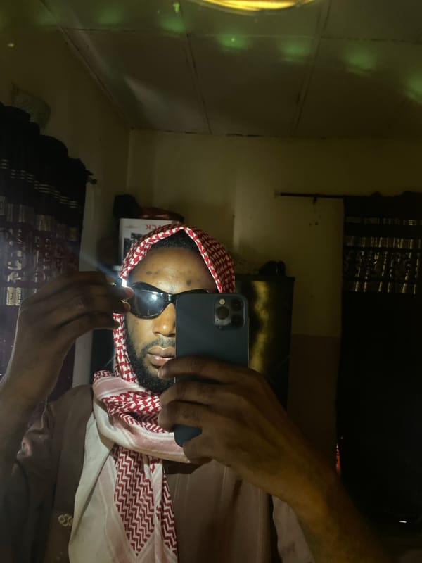 Man in keffiyeh takes multiple selfies in Lokoja, Nigeria