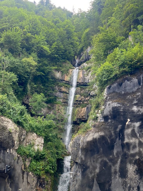 Hallstatt streets, rooftops, and waterfalls on a July afternoon