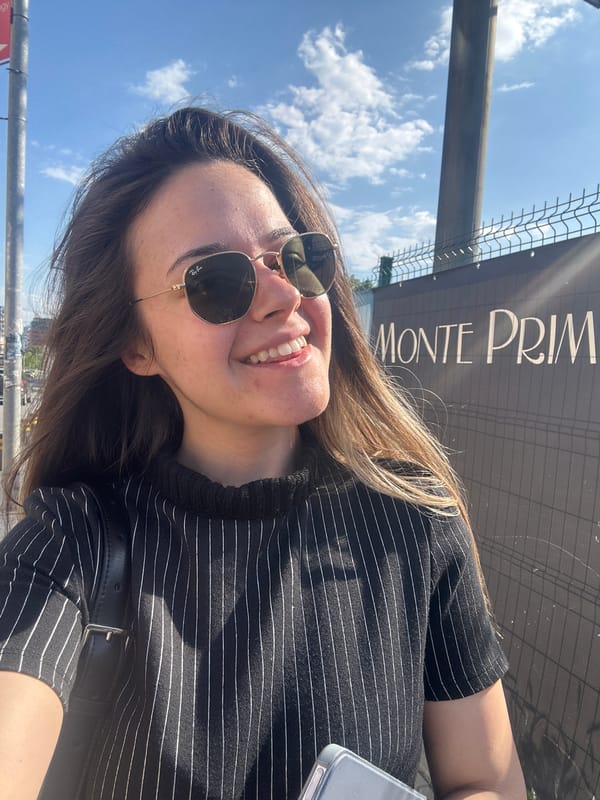 Woman takes morning selfies near Monte Prima sign in Sofia