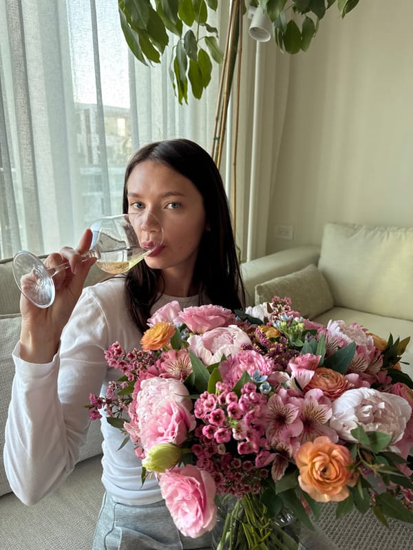 Woman enjoys afternoon terrace time with flowers in Eilat