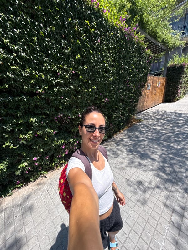 Noon stroll past Barcelona's glass towers and flowering walls.