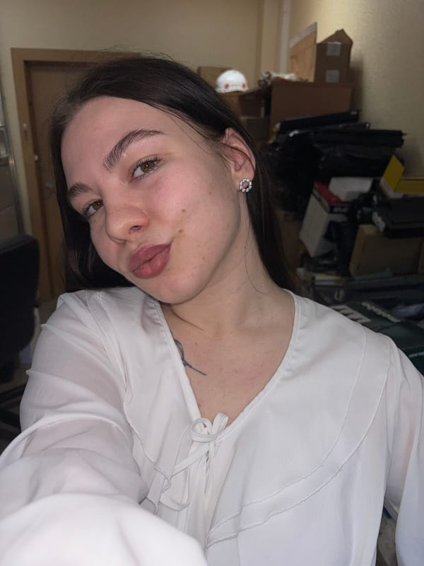 Woman in white blouse photographed indoors in Perm, Russia