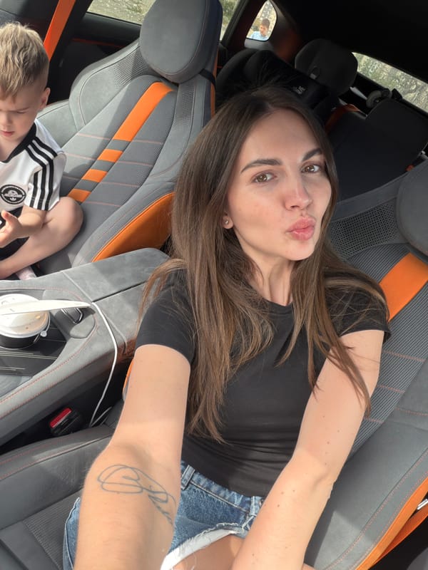 Adult takes selfie inside vehicle in Bishkek, Kyrgyzstan