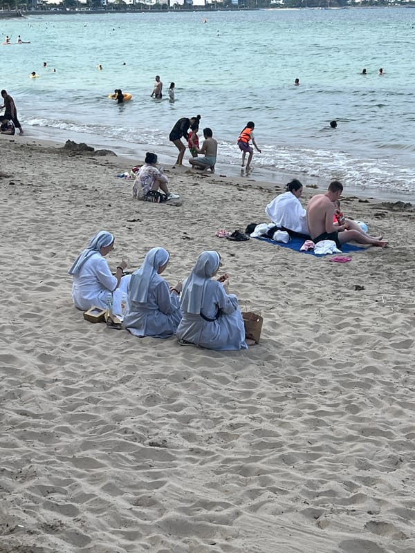 Beach gathering includes swimmers, couples, nuns in Bắc Nha Trang