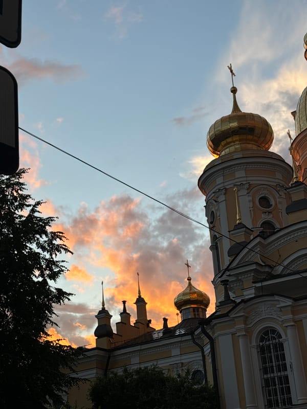 Double rainbow and golden-hour sky over Saint Petersburg