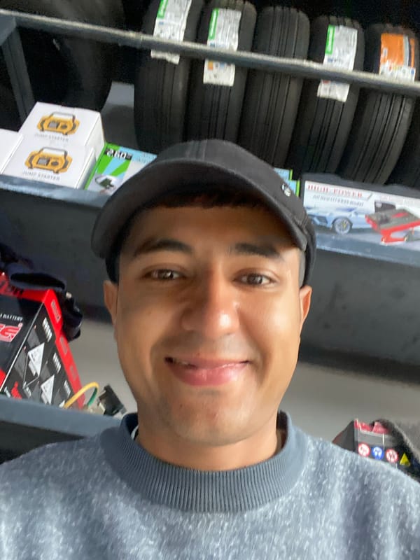 Man takes selfies in automotive store in Bukhara