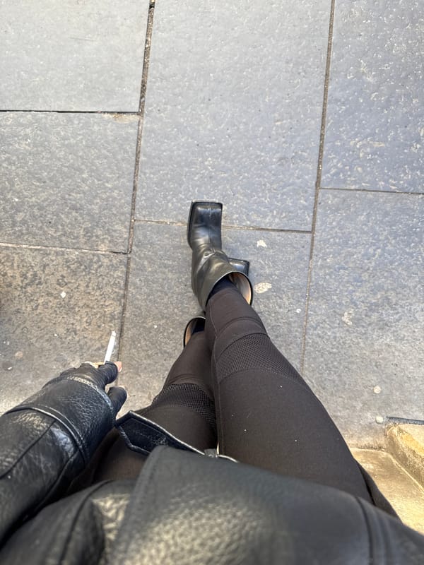 Person in black attire observed on Edinburgh sidewalk