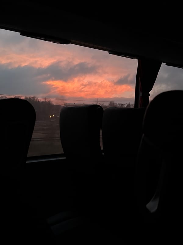 Twilight bus journey captured through window in Iksha, Russia