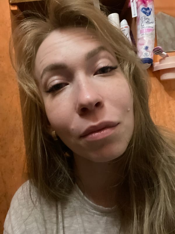 Woman takes selfies with jeweled phone in Perm apartment