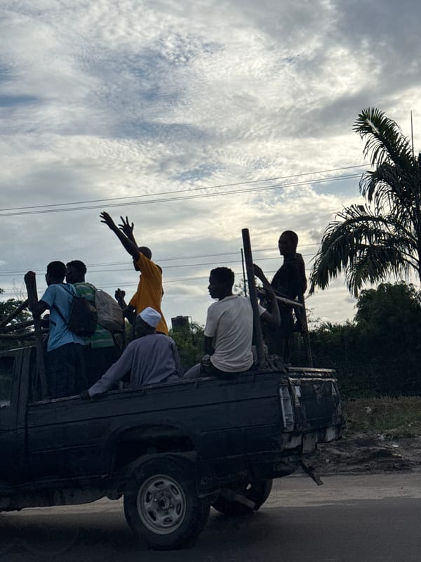 People ride in pickup truck bed in Lekki, Nigeria