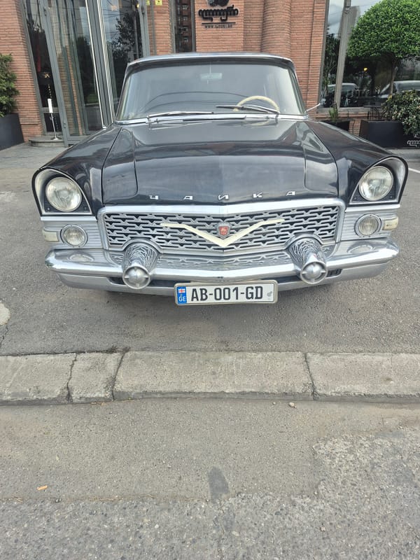 Vintage Soviet car and crowded bus spotted in Tbilisi