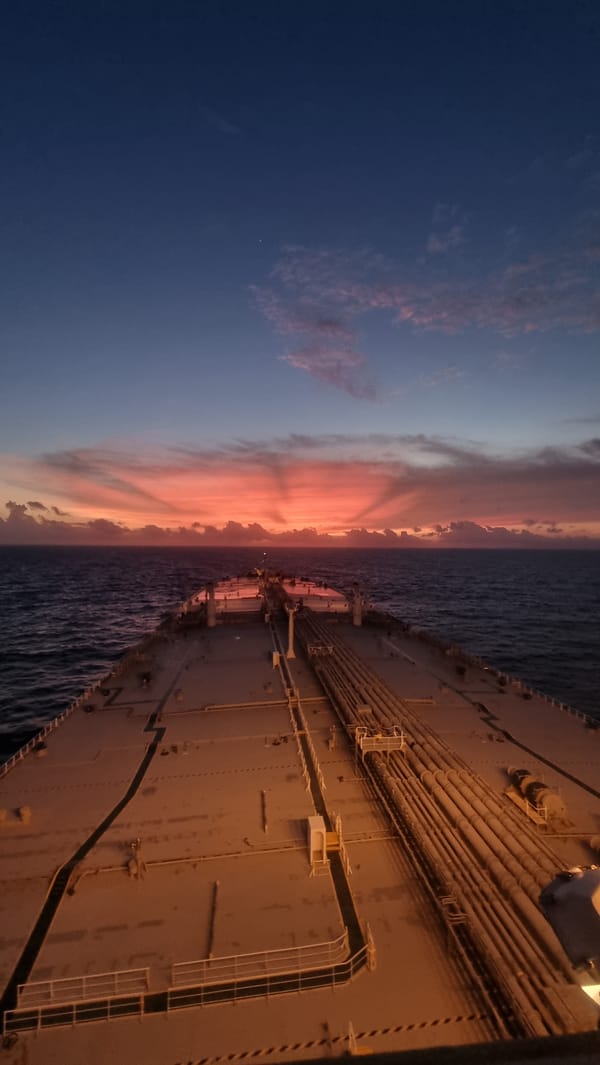 Cargo ship at sea off Sri Lanka during sunset