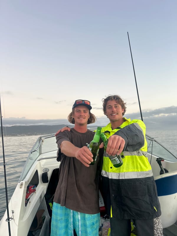 Men fishing from motorboat off Bellambi coast