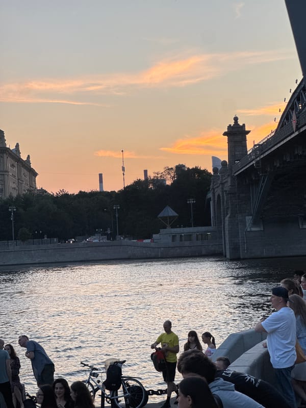 Social dancing on a Moscow riverfront deck at summer sunset