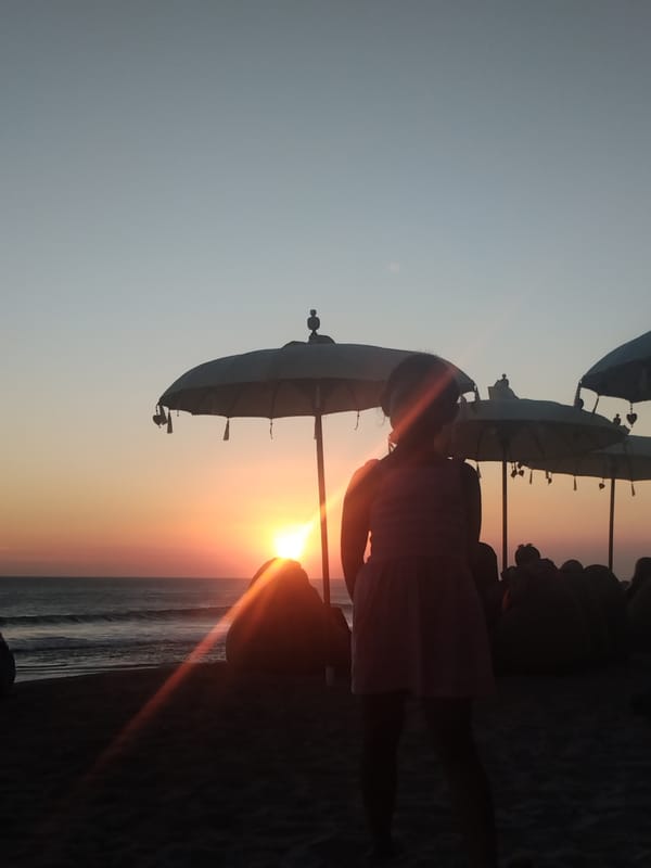 Family sunset gathering documented on North Kuta beach Indonesia