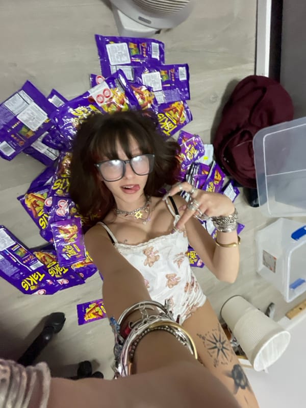 Woman Documents Late-Night Snack Session with Macarons and Takis