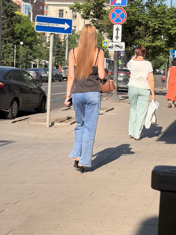 Summer street life along a Krasnoyarsk sidewalk
