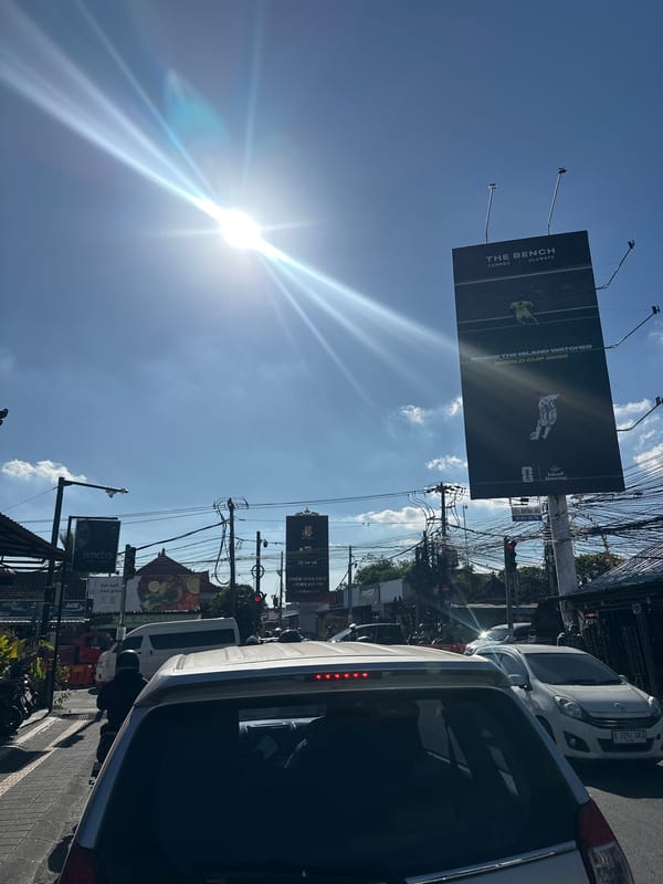 North Kuta street life: shops, scooters, temples, and overhead wires