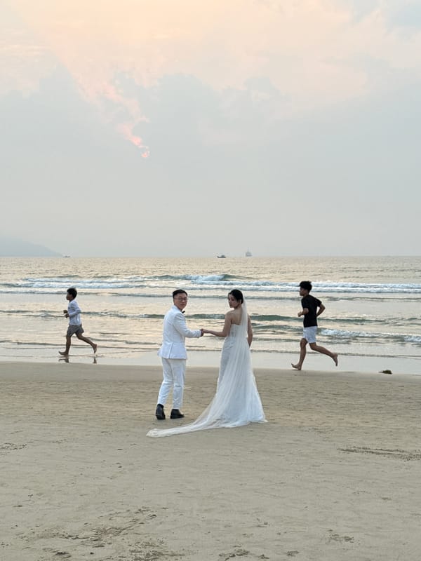 Wedding couple poses for beach photos in Đà Nẵng