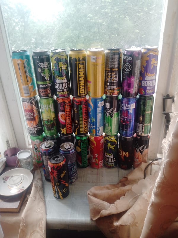 Energy drinks stacked near Russian-labeled fire extinguisher observed