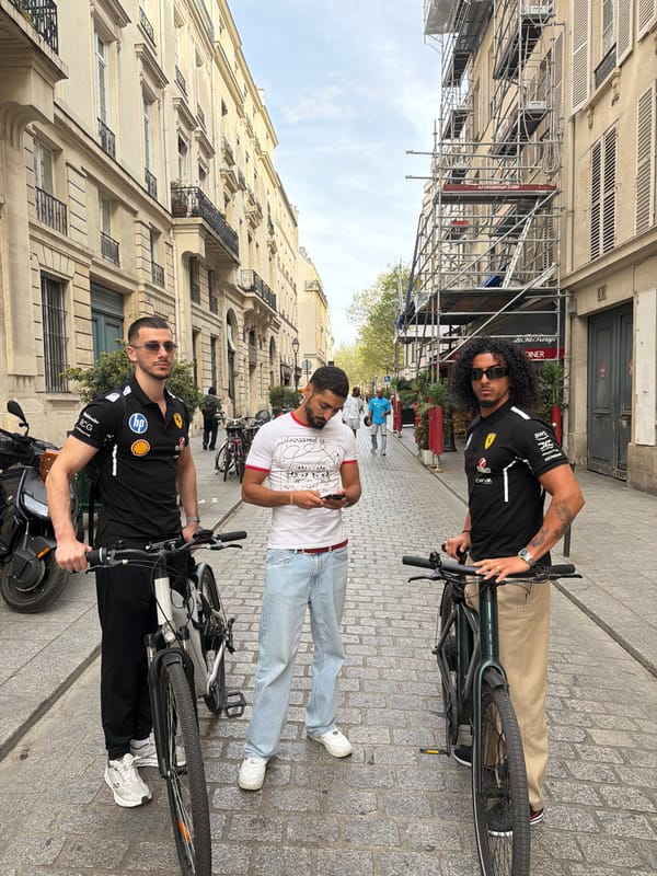 Everyday Paris street scenes captured: hanging shoes, parked motorcycle