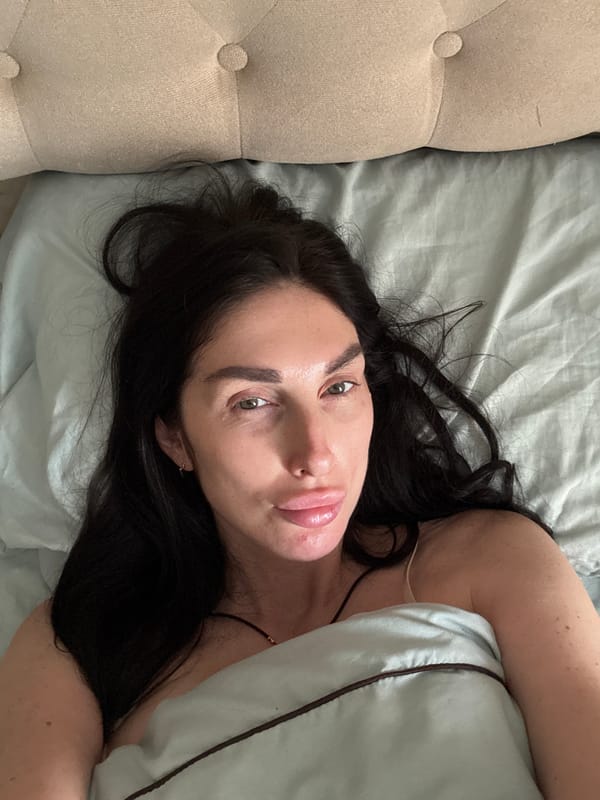 Slow morning in bed with a sleeping cat nearby