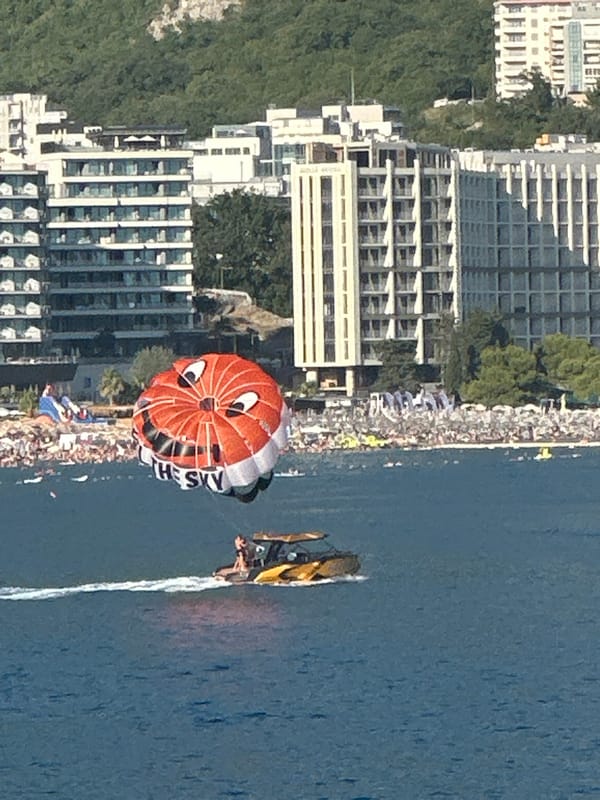 Cartoon-faced parasail flies over the Montenegrin coast
