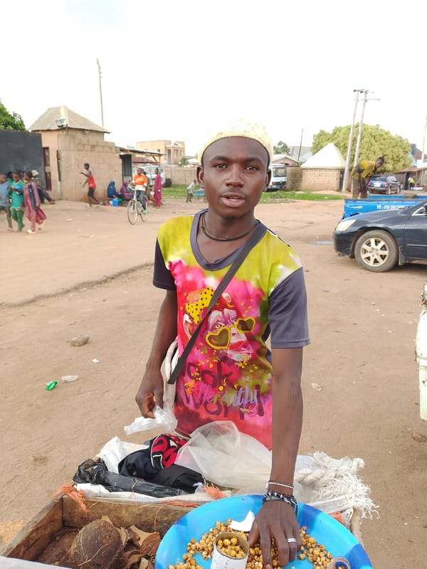 Everyday street life in a Bukuru neighborhood marketplace and yard