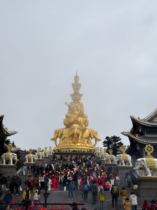 Fog shrouds Buddhist temples and golden statue at Emei Shan