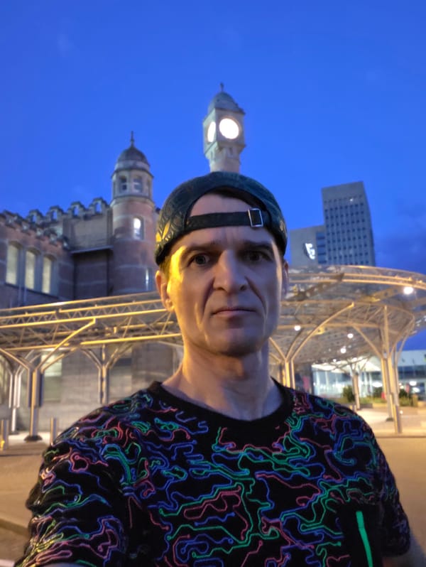 Selfie in front of a turreted brick clock tower building