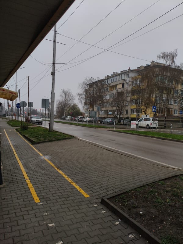 Overcast street scene captured near bus stop in Dobrich