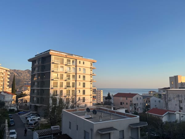 Woman observed at window overlooking Boreti Montenegro residential area