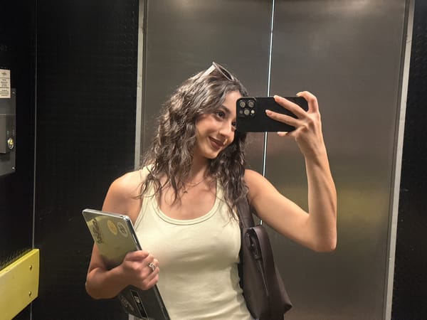 Woman Takes Selfies While Carrying Laptop in Milan