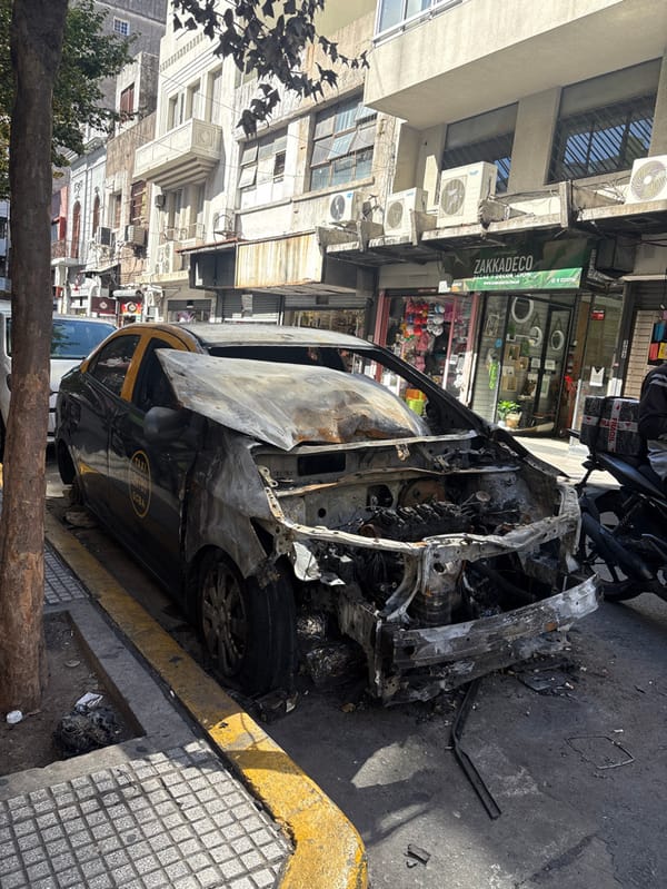 Fire-damaged taxi and street scenes documented in Buenos Aires