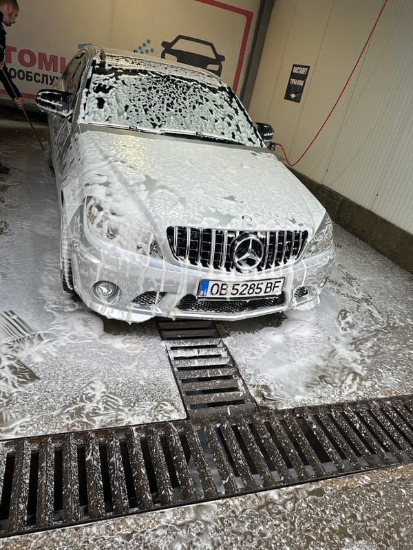 Silver Mercedes gets washed at car wash facility